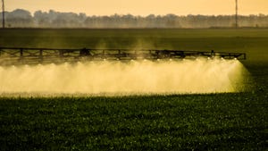 Jets of liquid fertilizer from the tractor sprayer