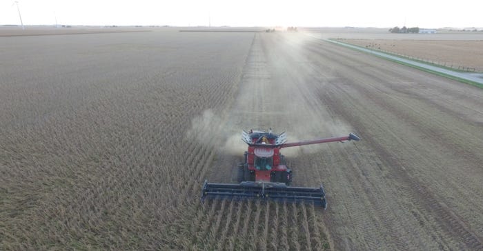 aerial photo of combine harvesting beans