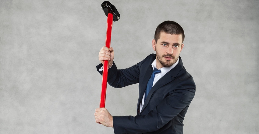 Man holding big hammer ready to swing