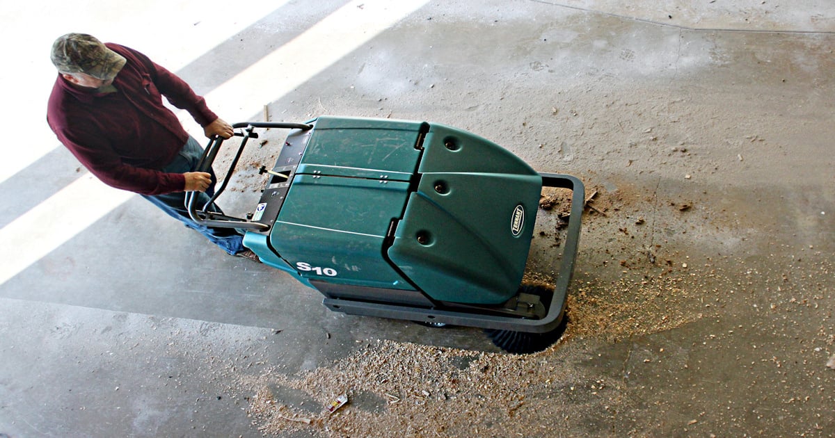 Team FIN tests out Tennant industrial floor sweeper