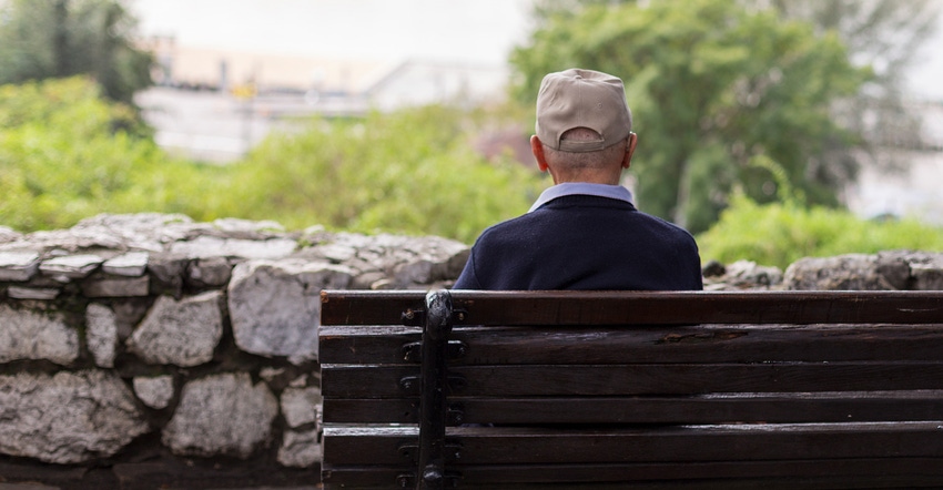 Elderly man sitting on a park bench