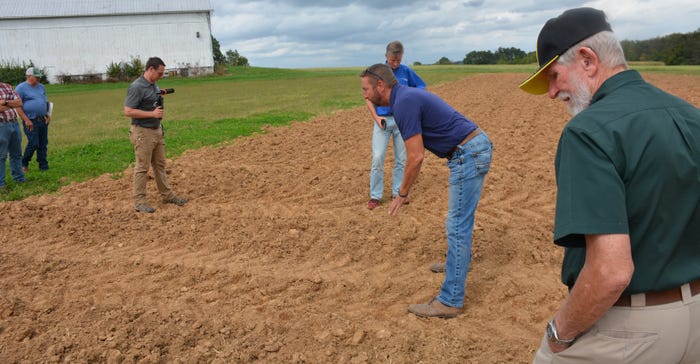 Scott Sloan, ag product manager for Titan International, demonstrates the effects of a larger tire footprint on the soil