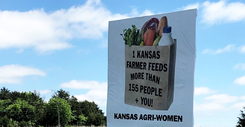 Newest highway signs that read “1 Kansas Farmer Feeds More than 155 People + YOU!” 