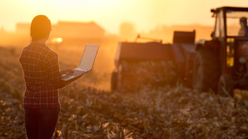 Woman with laptop in the field