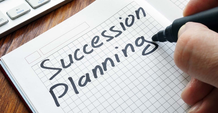 Man is writing succession planning in the book.