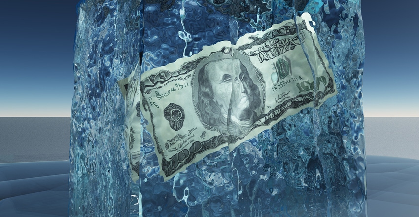 a hundred dollar bill encased in a block of ice