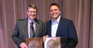 Kevin Winkel  and Clark Gerstacker holdilng master farmer plaques