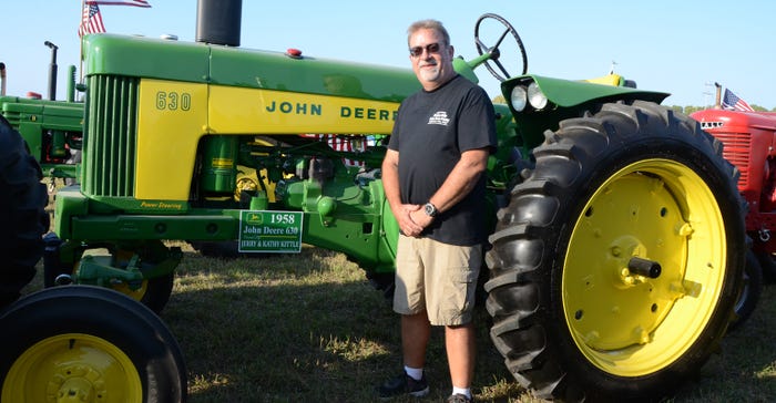 Jerry Kittle standing next to a 1958 John Deere 630 tractor