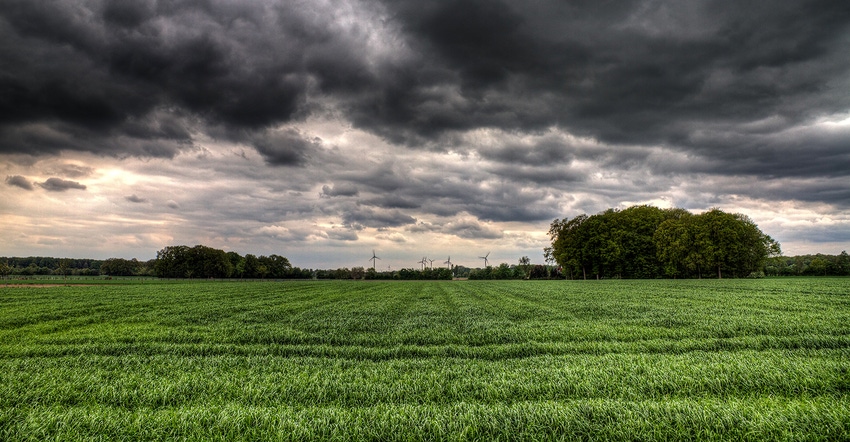 stormy sky over green field