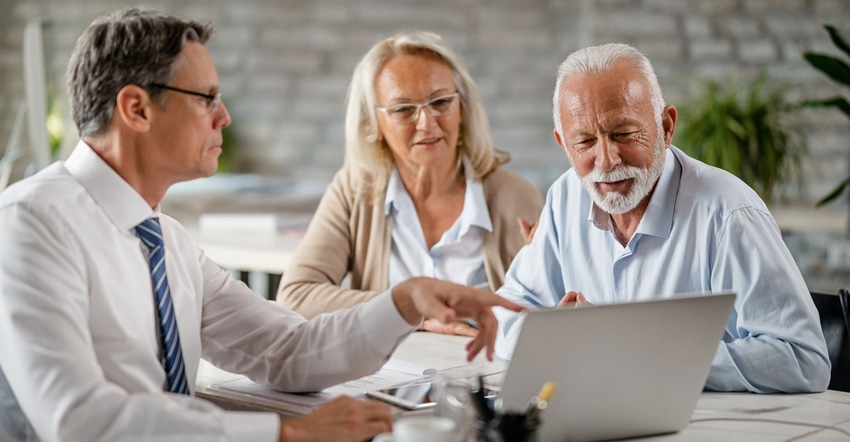 Mature couple in conversation during loan consultation Mature couple in conversation during loan consultation