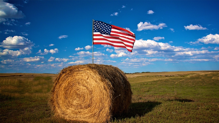 bale of rolled hay with an American flag