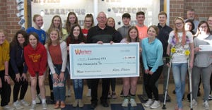 Ken Dean, manager of the Western Farm Show, presents a $1,000 ceremonial check to the Louisburg High School FFA which was a w