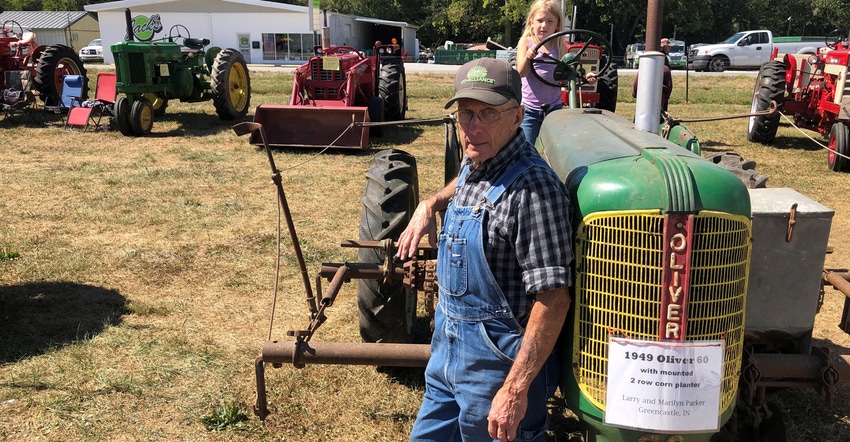 Larry Parker with great-granddaughter, Maddie Lawson, and two-row mounted Oliver planter on a late-model Oliver 60 tractor