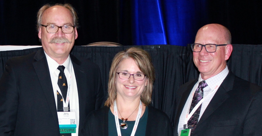 Stacy Pollock receives AAVLD award, flanked by Jerry Torrison (left) and Dale Lauer.