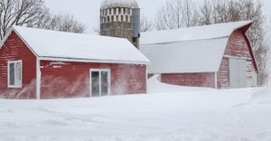 red farm buildings in deep snow