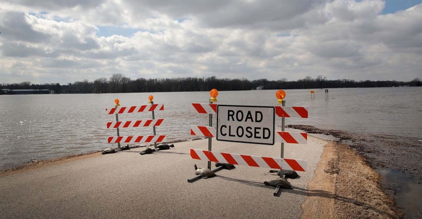 Flooding with Road Closed sign