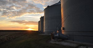 grain bins at sunset
