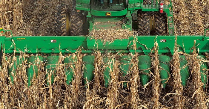 John Deere combine harvesting corn