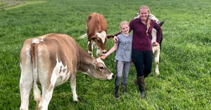 farmer Jeni Malott from Boonsboro, Md., with her daughter Vivian and some cows in the pasture