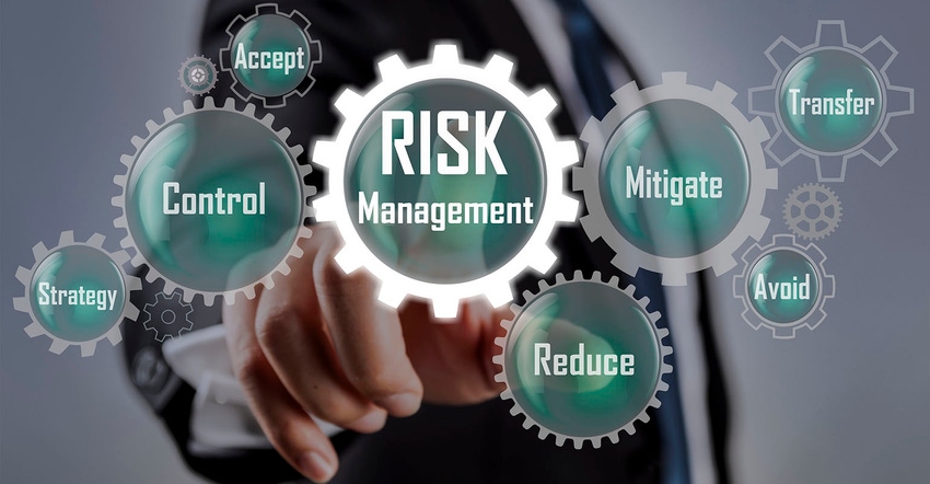 Businessman pointing at risk management concept on screen Businessman pointing at risk management concept on screen