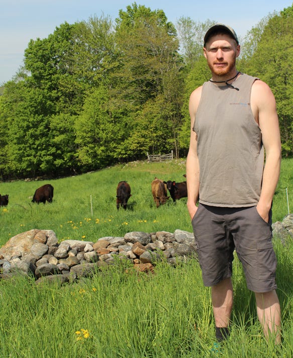 Jeff Moore standing in front of field where cattle are grazing