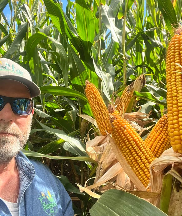 Drew Haines standing next to corn