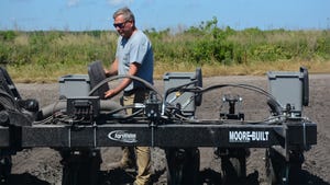 Eric Cahoon filling cotton planter hopper