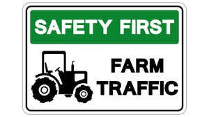 A sign for safety first farm traffic