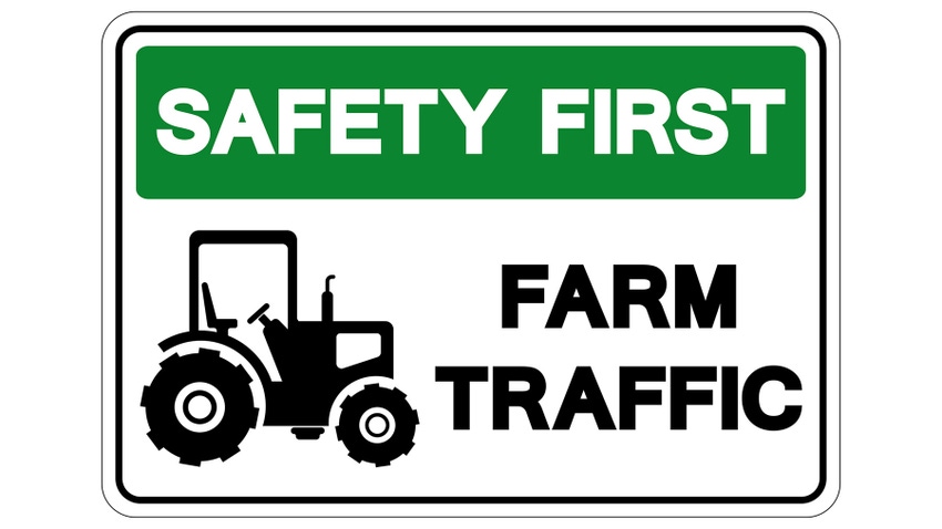 A sign for safety first farm traffic