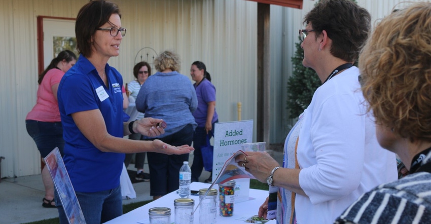 Joan Ruskamp uses M&Ms to compare levels of estrogen in different foods, in a demonstration at a CommonGround event. 