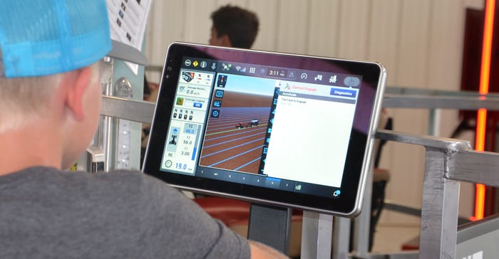 Boy looks at yield monitor during the Farm Progress Show