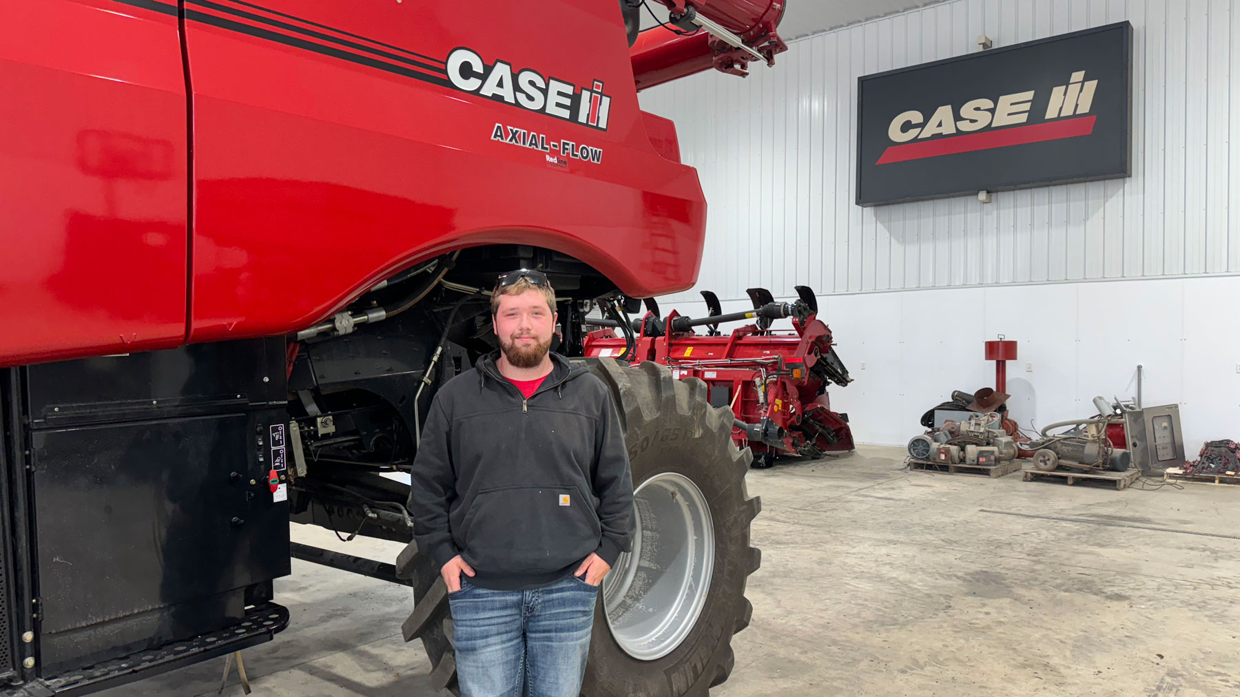 Jessup Hunt stands beside a Case IH combine