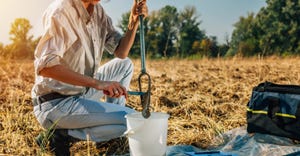 Woman taking soil sample
