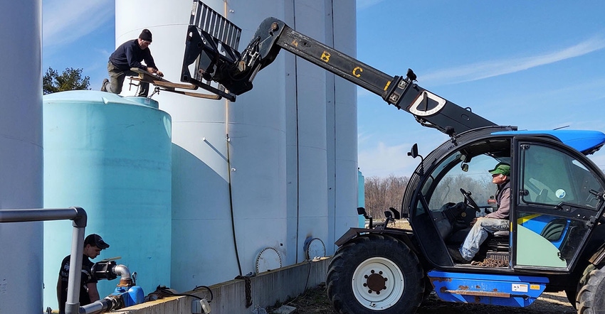 Men working near storage tanks