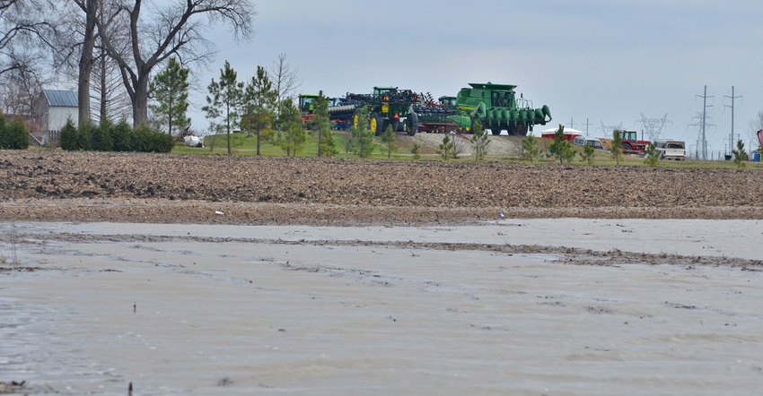 machinery on hill above flooded field
