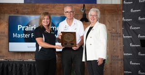 Holly Spangler presents Ted and Janet Mottaz the Master Farmer award