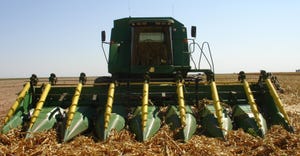 Tractor with rotating cones in corn field with fallen corn