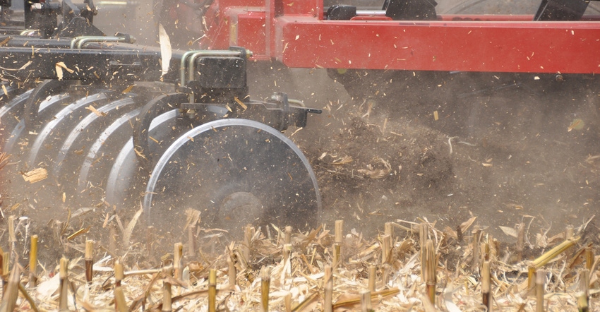 closeup of tillage equipment working a field