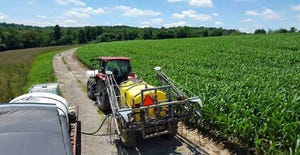 Close-up view of sprayer in corn field