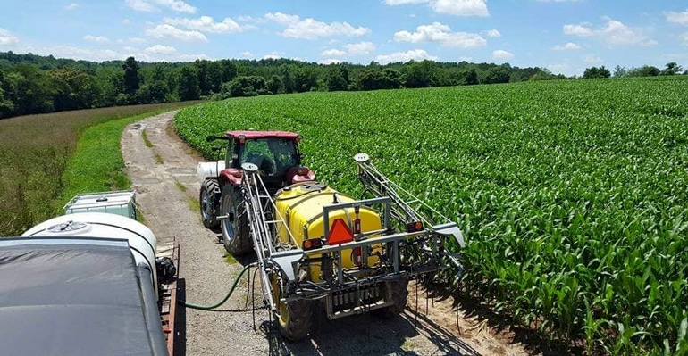 Close-up view of sprayer in corn field