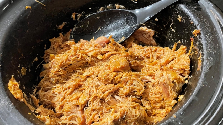 chicken taco meat in slow cooker with black spoon chicken taco meat in slow cooker with black spoon