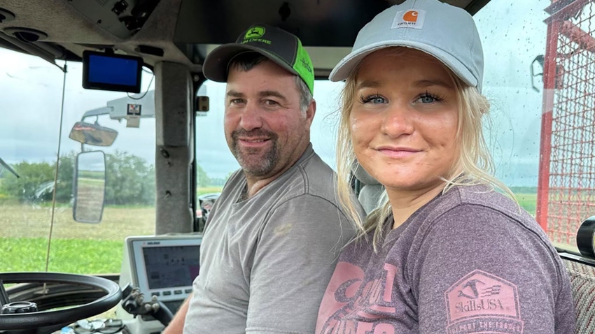 Matt Frostic and daughter Reagan Sprague in the cab of a tractor