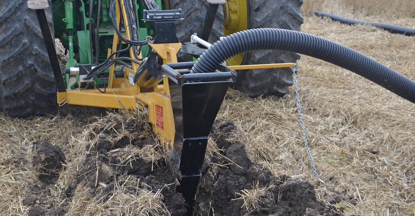drainage tile being installed on farmland