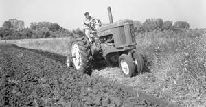 old photo of tractor pulling moldboard plow