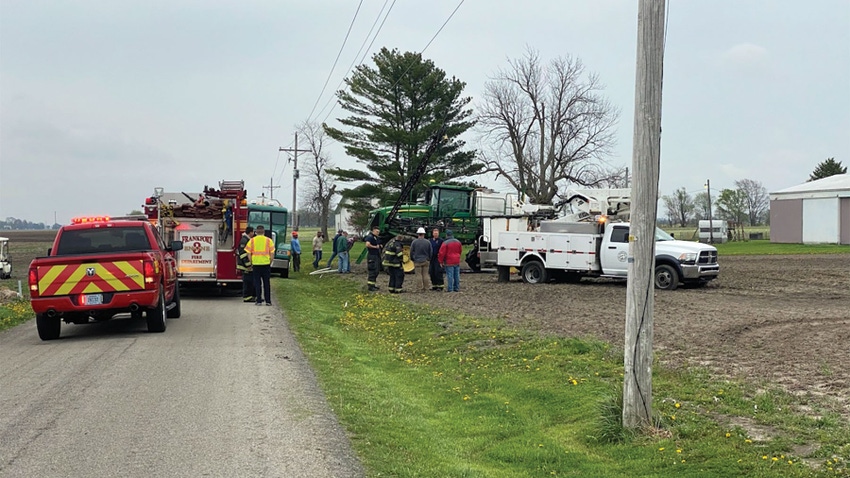 First responders at a scene involving a tractor and power lines