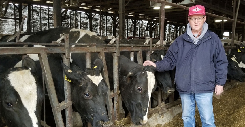 David Wood, owner of Eildon Tweed Farm, beside cows in the barn