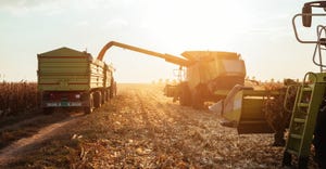 combine loading wagon during corn harvest