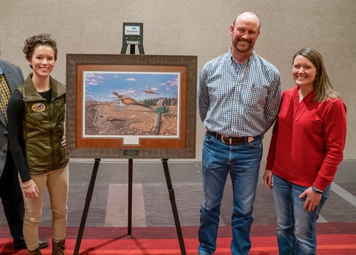 Melissa Shockman, Pheasants Forever precision agriculture and conservation specialist, Christof Just and his wife, Kelli pose after presentation of Farmer of the Year award