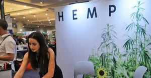 woman at a display booth at a hemp convention