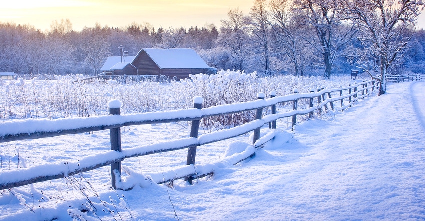 scenic farm buildings and fence in snow